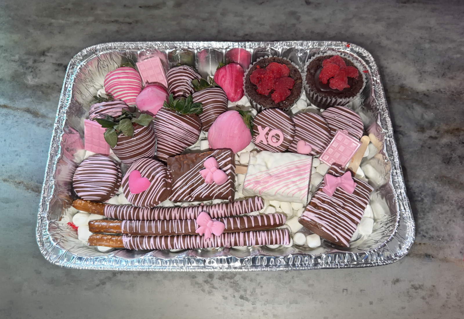 Assorted Valentine's treat tray with strawberries and pretzels